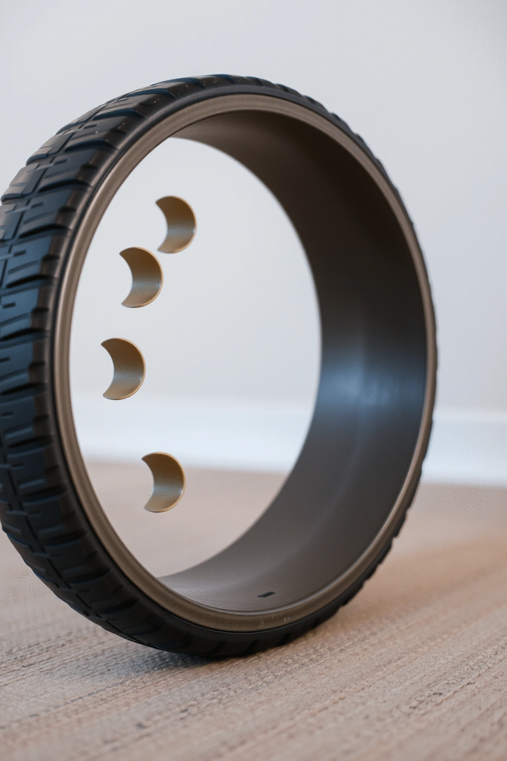 Close-up of a yoga wheel on a textured background, illustrating pressure points